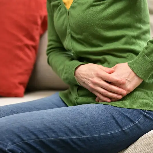 PCOS Woman holds painful stomach